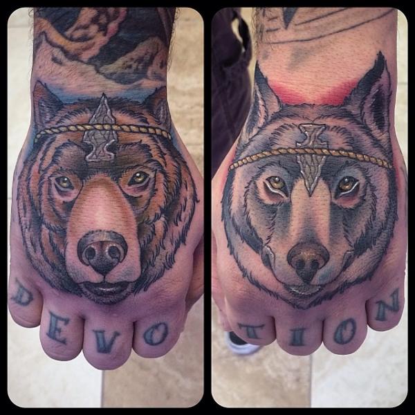 Back of Hand Bear and Wolf tattoo by Earth Gasper Tattoo