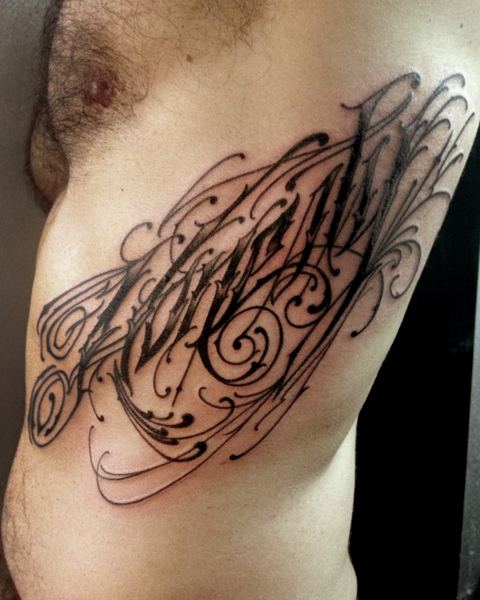 Body Side Lettering tattoo by Three Kings Tattoo