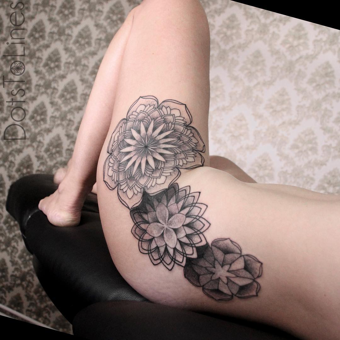 girl's hip decorated with several beautiful mandala tattoos