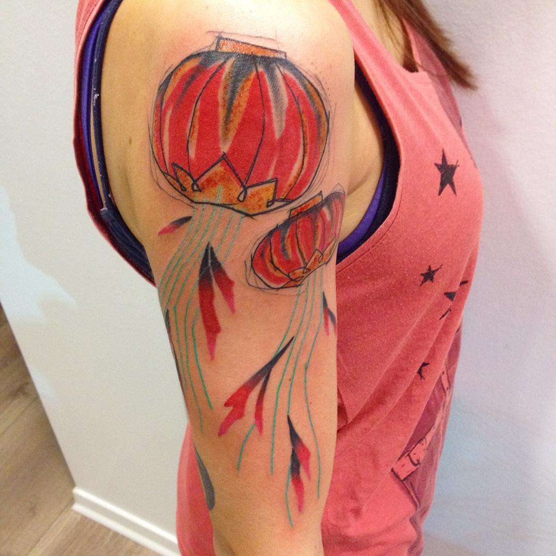Chinese or sky lanterns are flying on the shoulder of the girl - great tattoo design