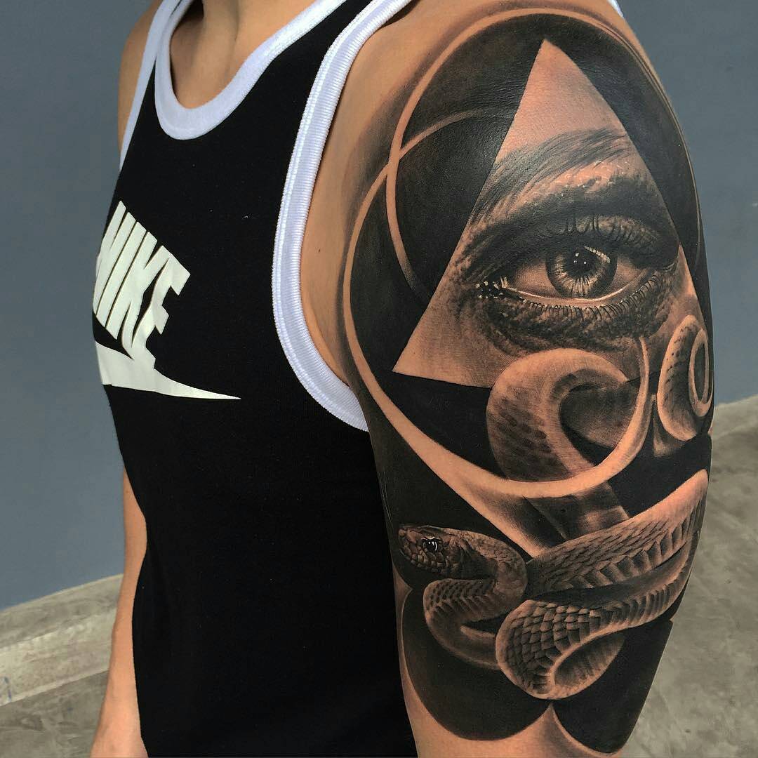 triangle eye and snake tattoo on shoulder