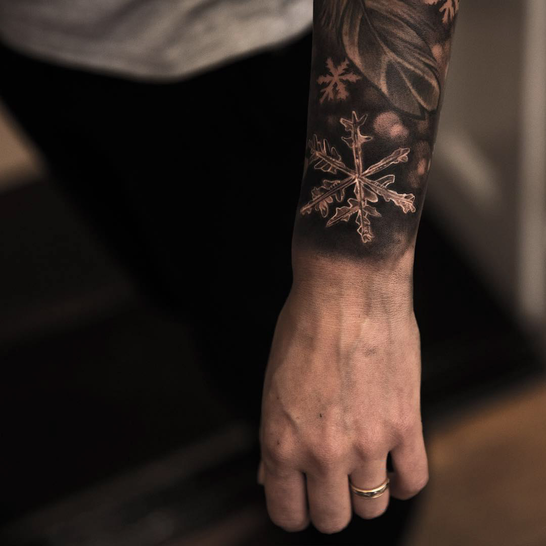 winter snow flake tattoo on wrist