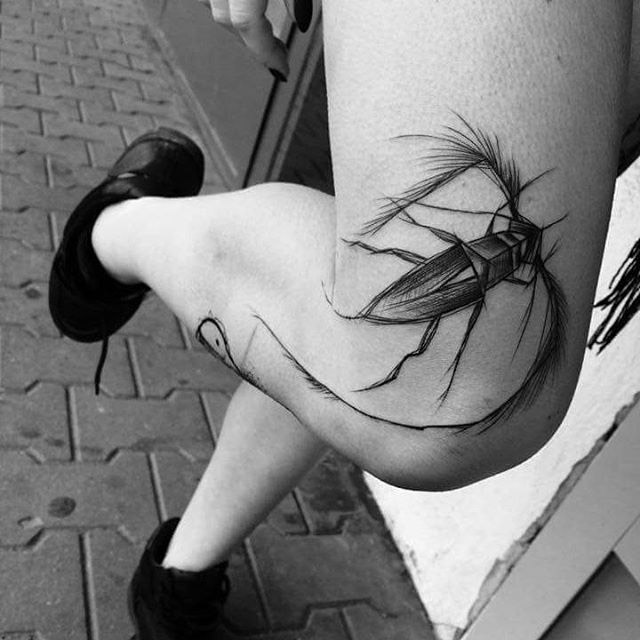 beetle tattoo on a knee