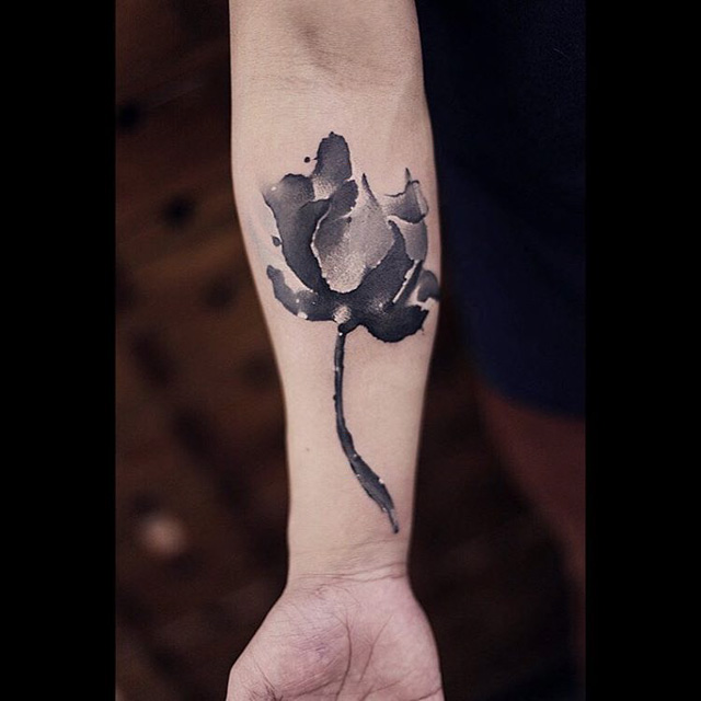 grey flower inner arm tattoo
