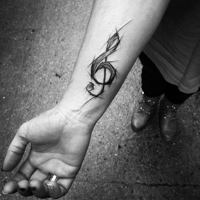 wrist treble clef tattoo