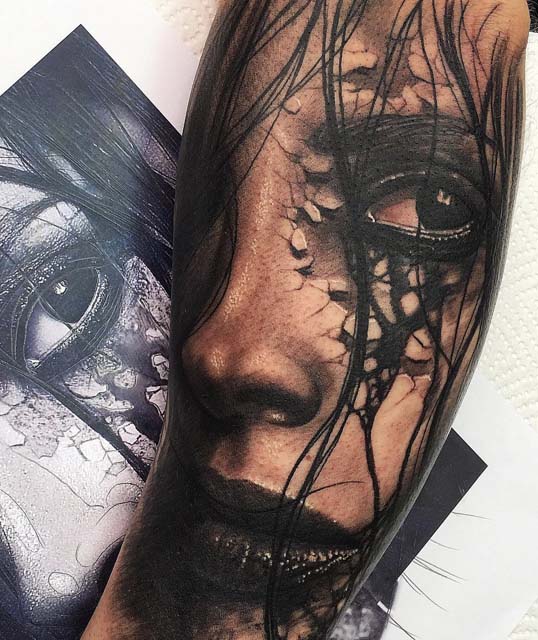 face 3D tattoo on arm