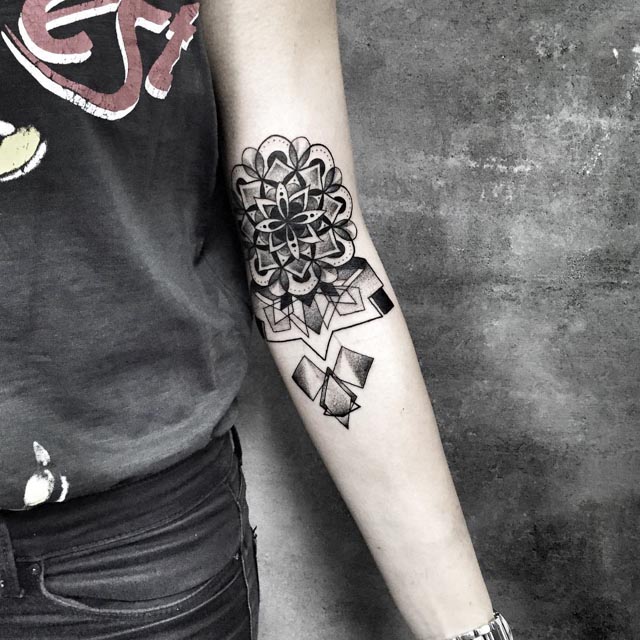dotwork mandala geometry tattoo on inner elbow