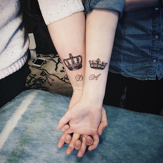 couple crown tattoos on forearms