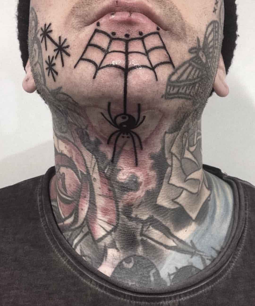 chin tattoo spider web