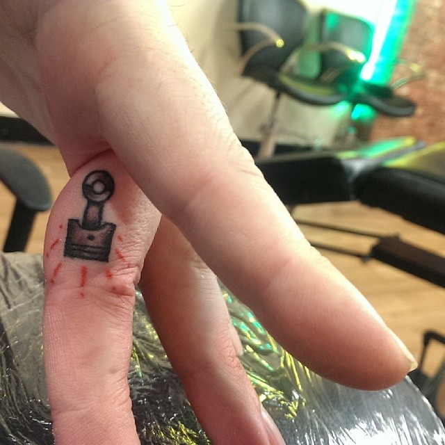 Finger Tattoo Piston by Luke Brundish