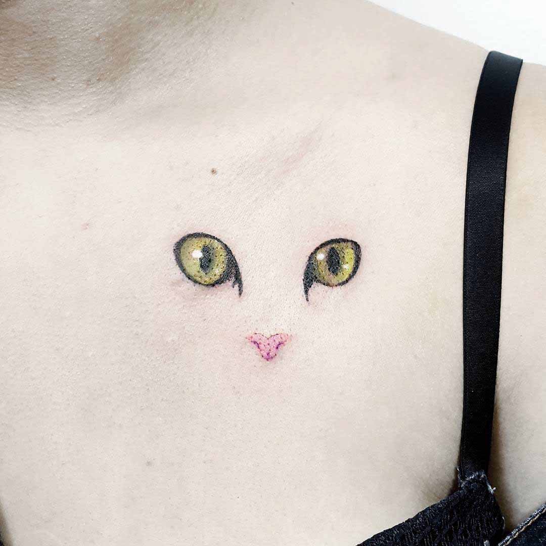 cat eyes tattoo on collar bone