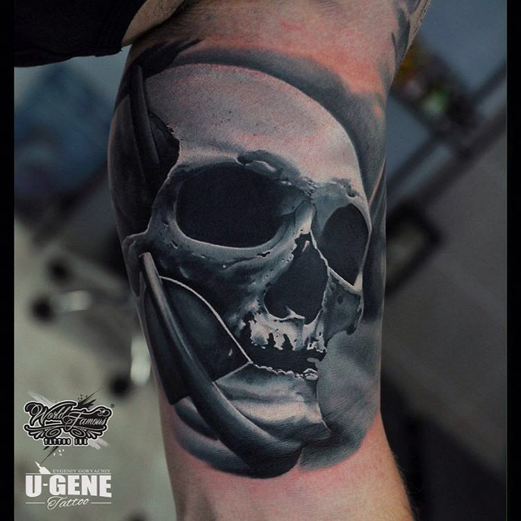 grey skull tattoo on bicep