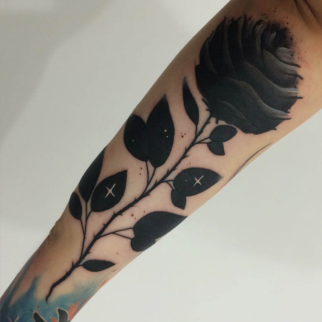 rose tattoo black on forearm