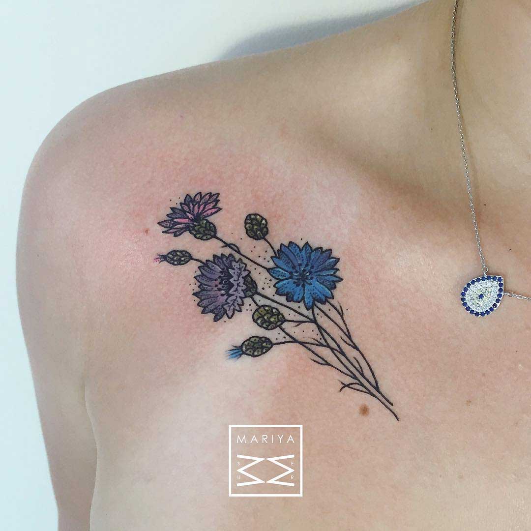 blue flowers tattoo on collar bone