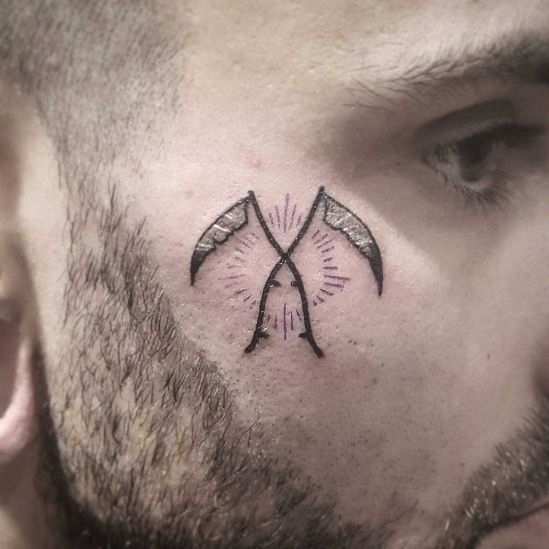 Crossed Scythes Tattoo on Face by mewo llama