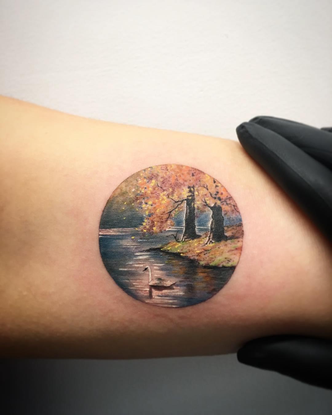 arm tattoo landscape circle-shaped