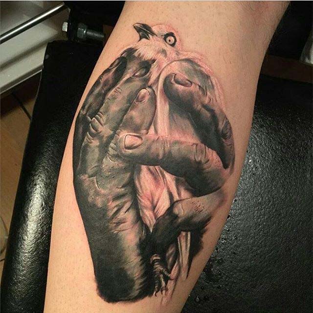 calf tattoo dove in hands