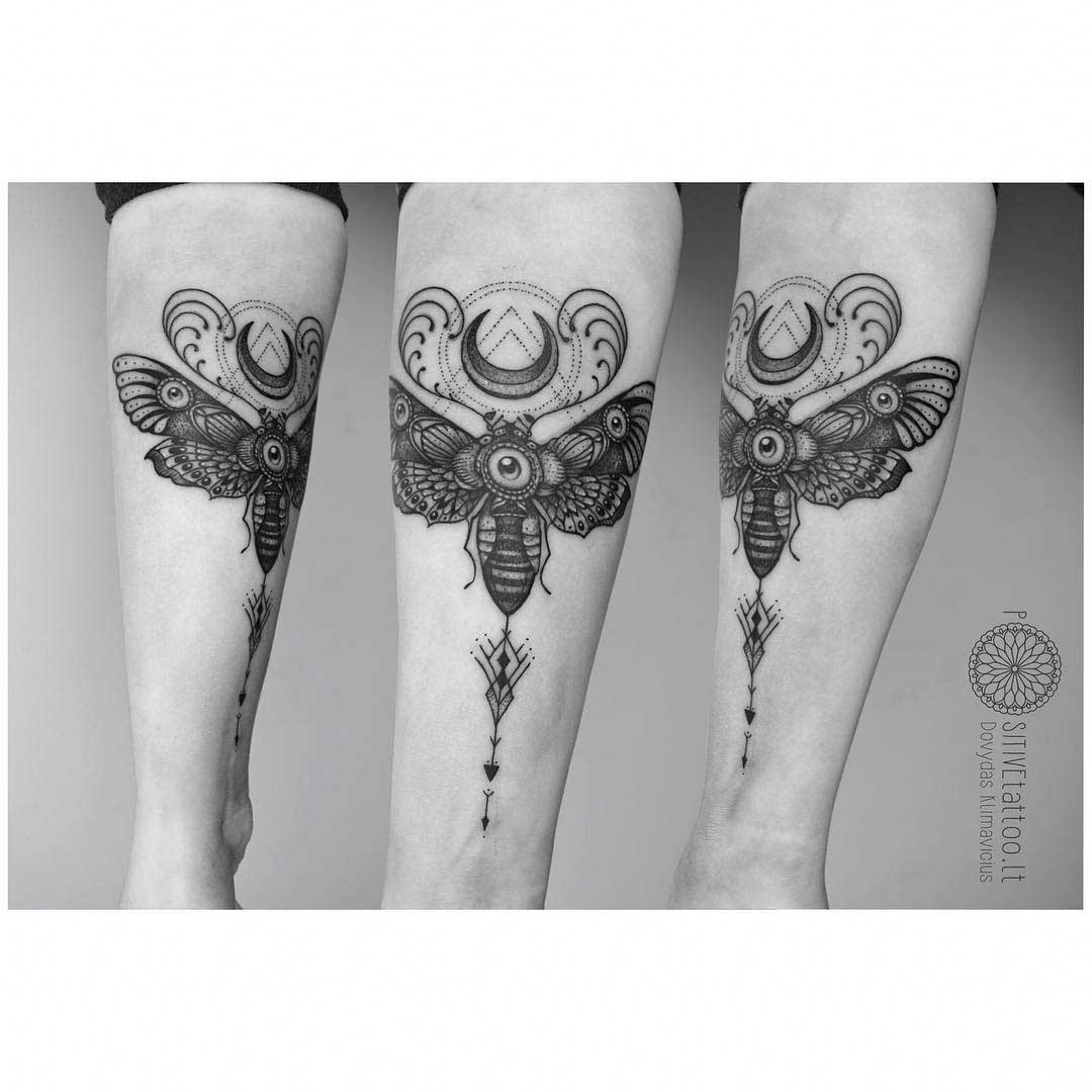 moth tattoo with moon on arm