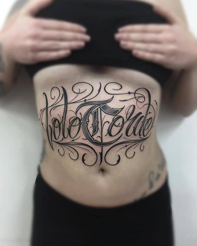 chicano tattoo lettering on stomach