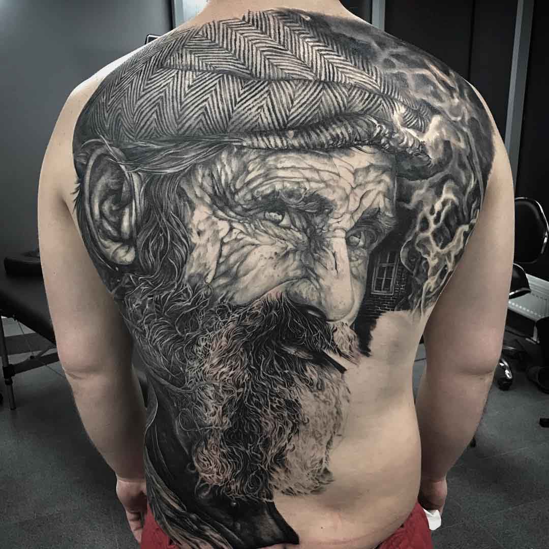 black and grey realistic full back tattoo
