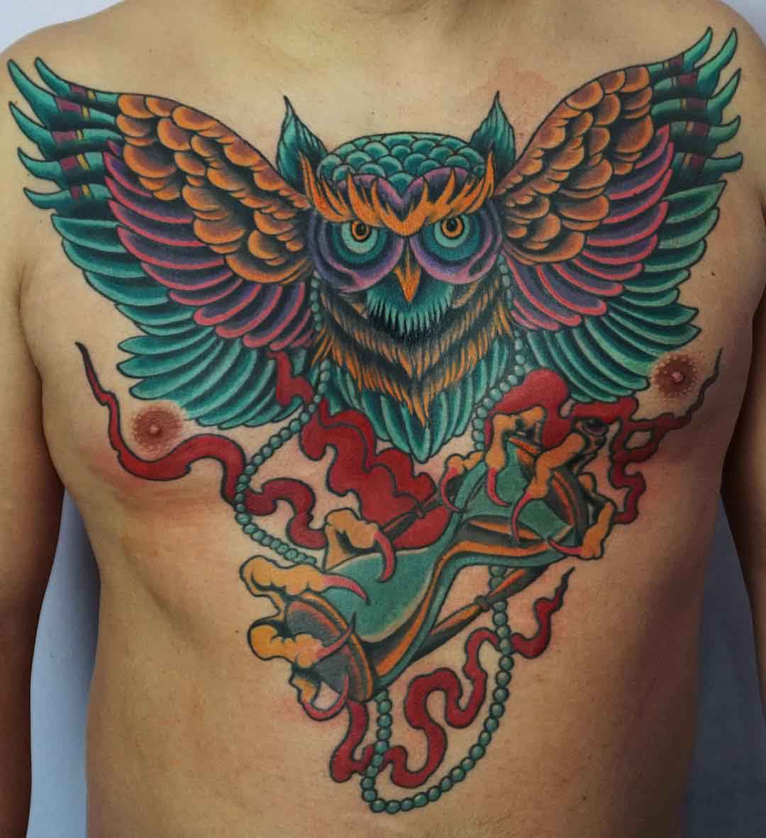 colorful owl tattoo on chest