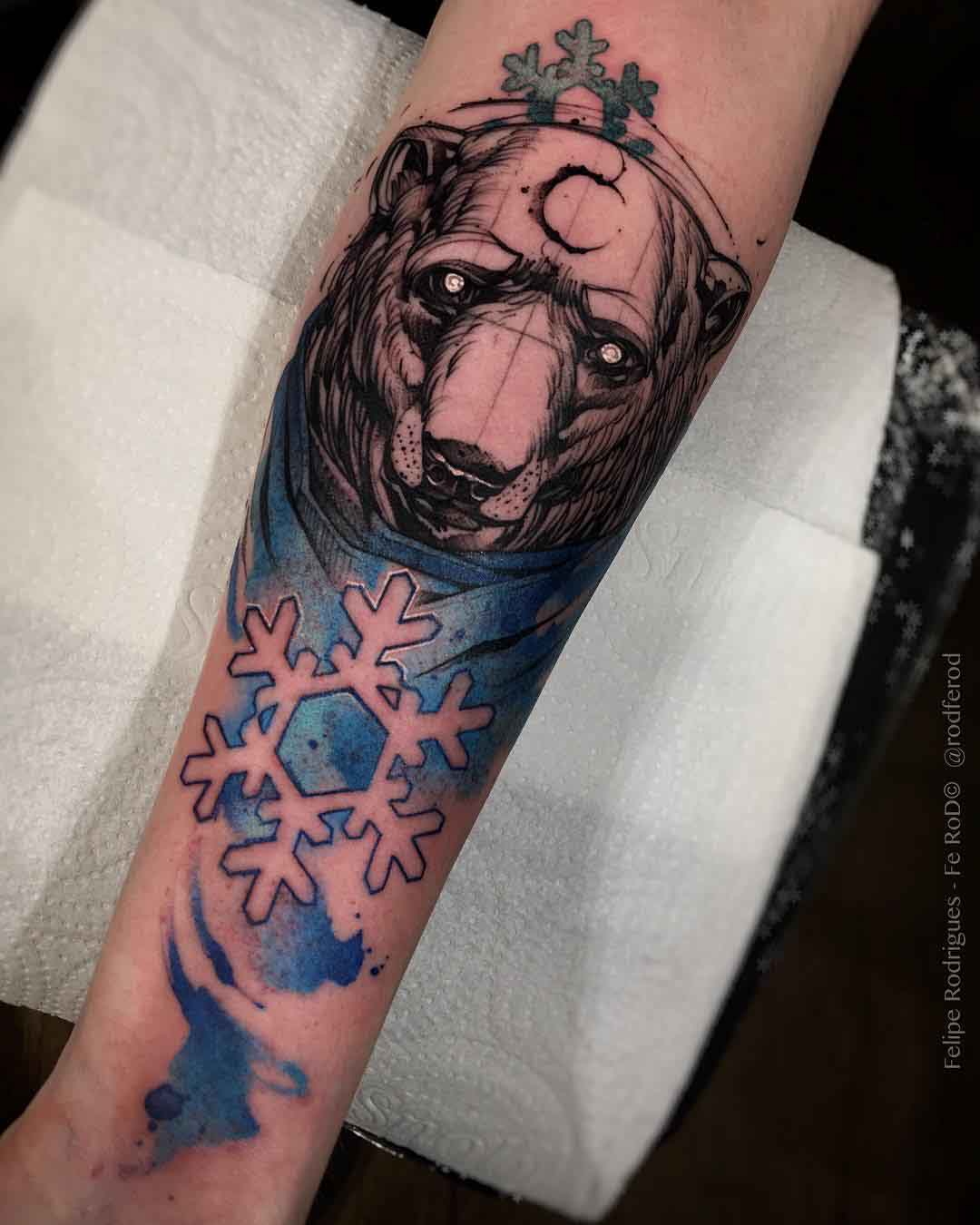 Single needle polar bear tattoo on the bicep.