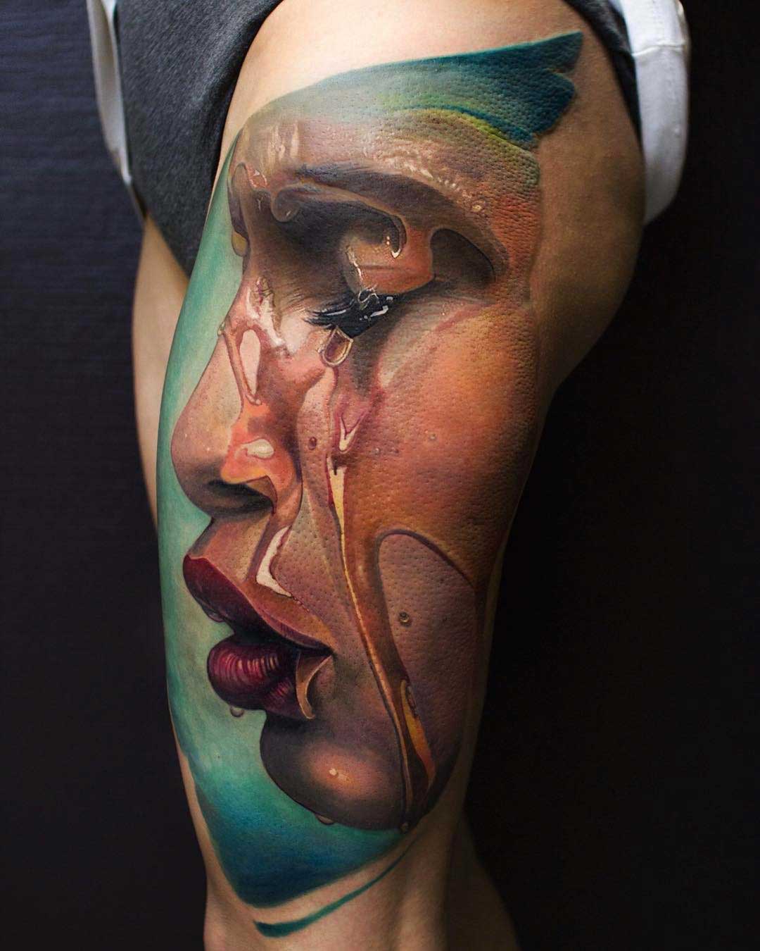 realistic tattoo on thigh side face with water flood