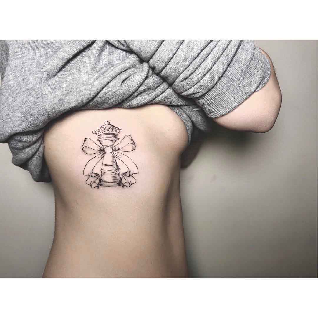 rib tattoo chess piece with bow