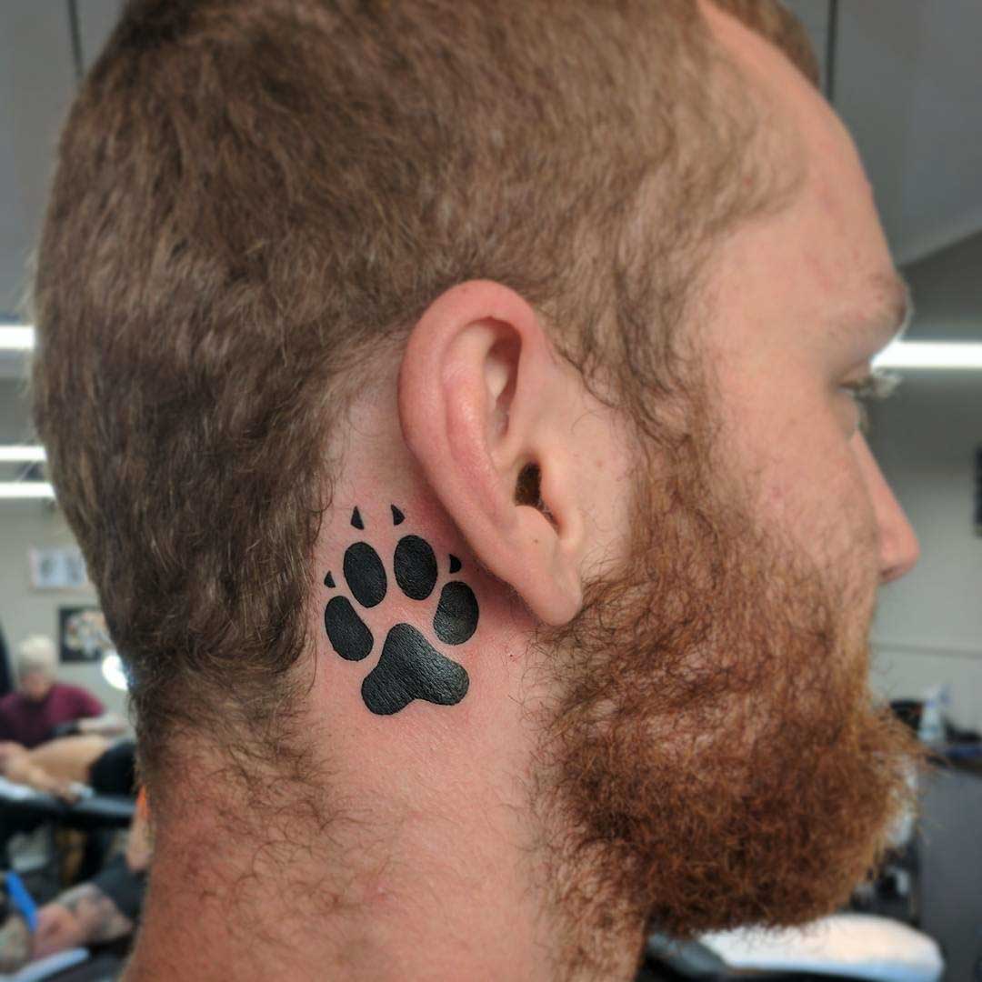 behind ear tattoo of a dog paw