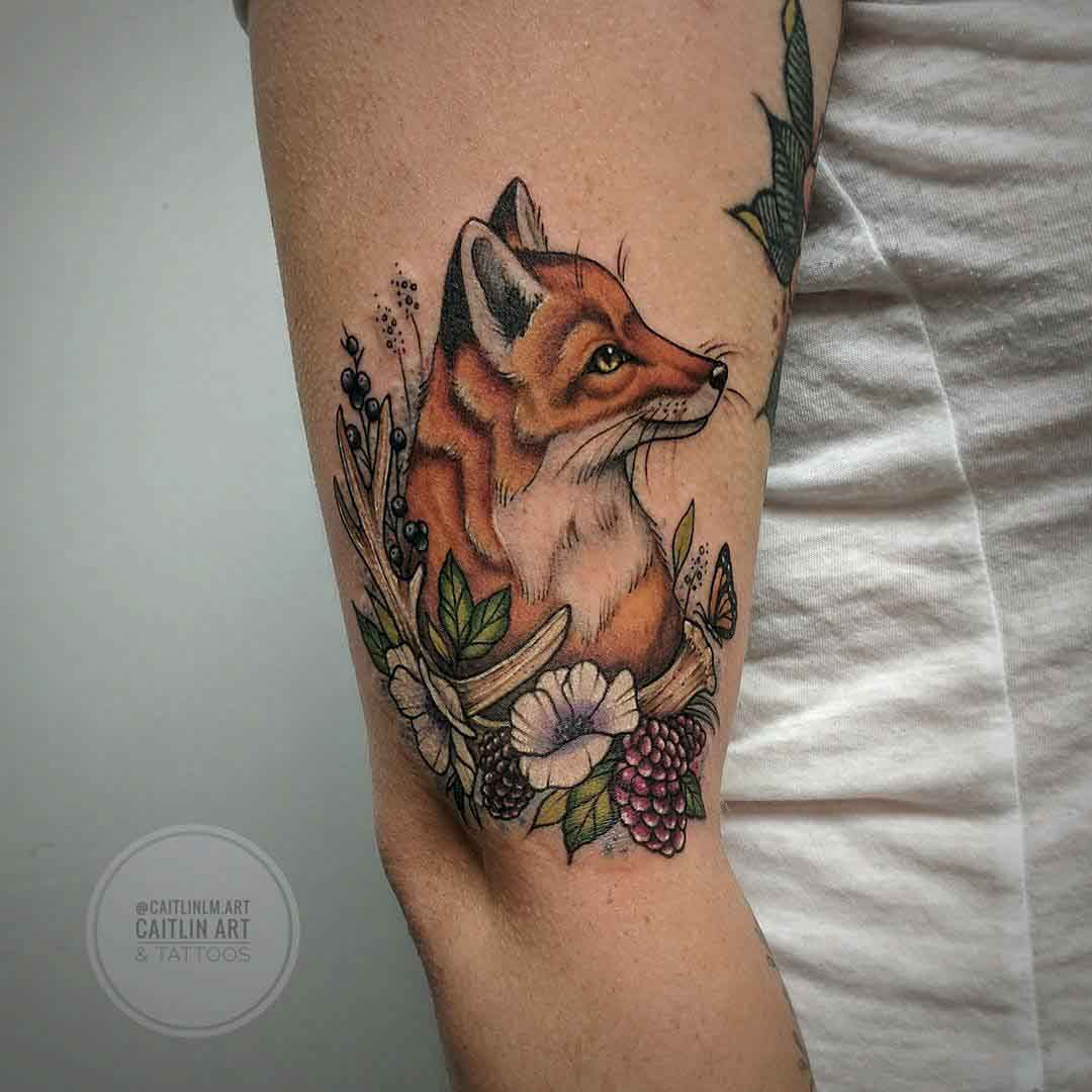arm tattoo of fox in berries