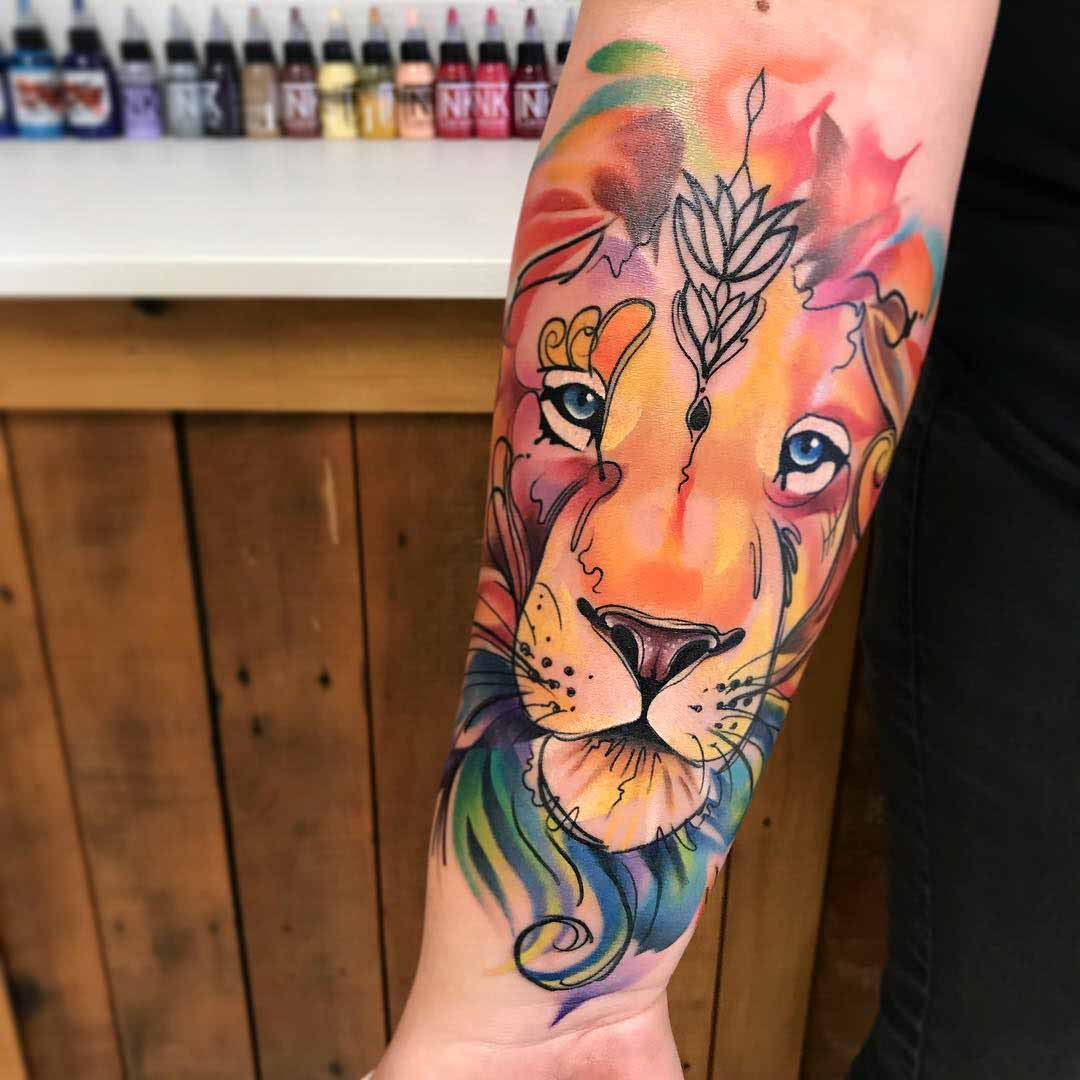 arm tattoo lion face watercolor tattoo style
