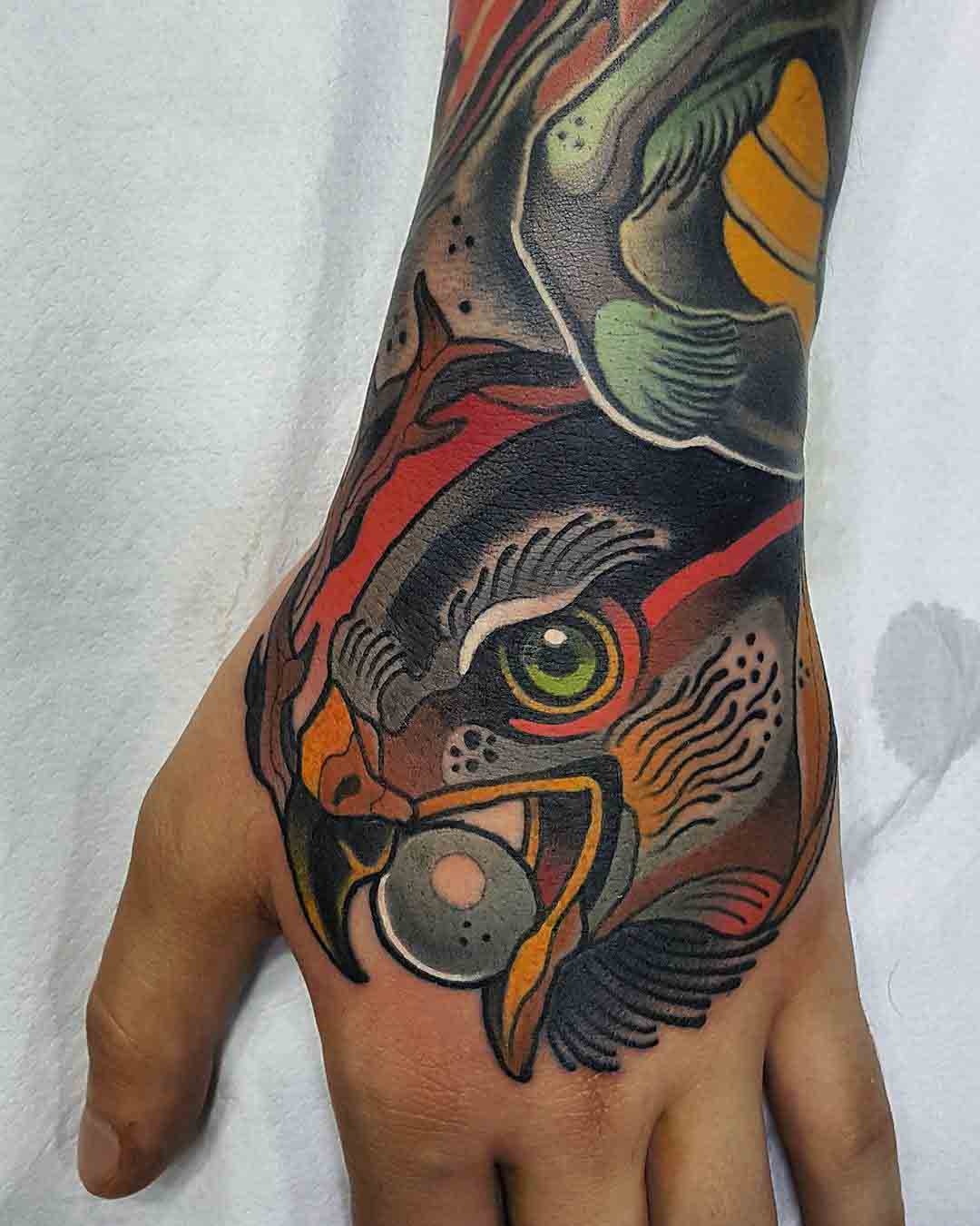 hawk tattoo on hand traditional style