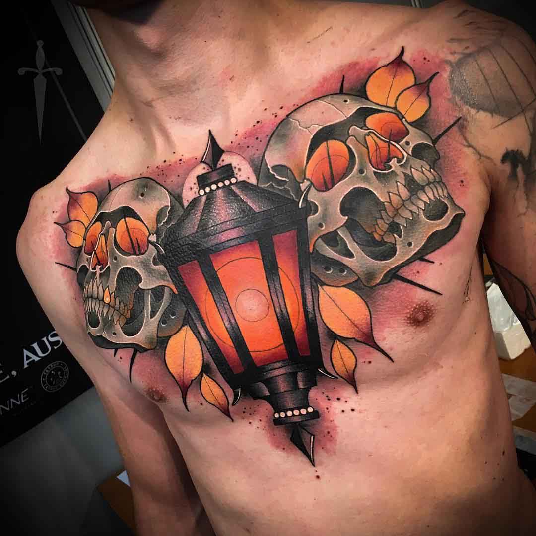 chest tattoo lantern and two skulls