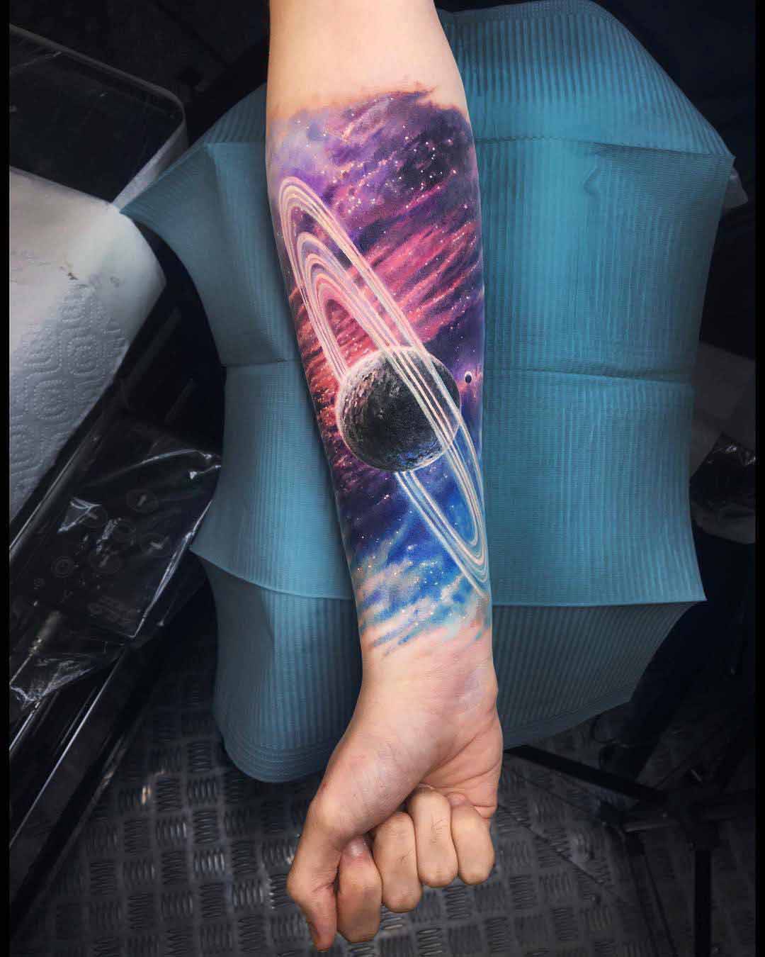 arm tattoo planet with rings
