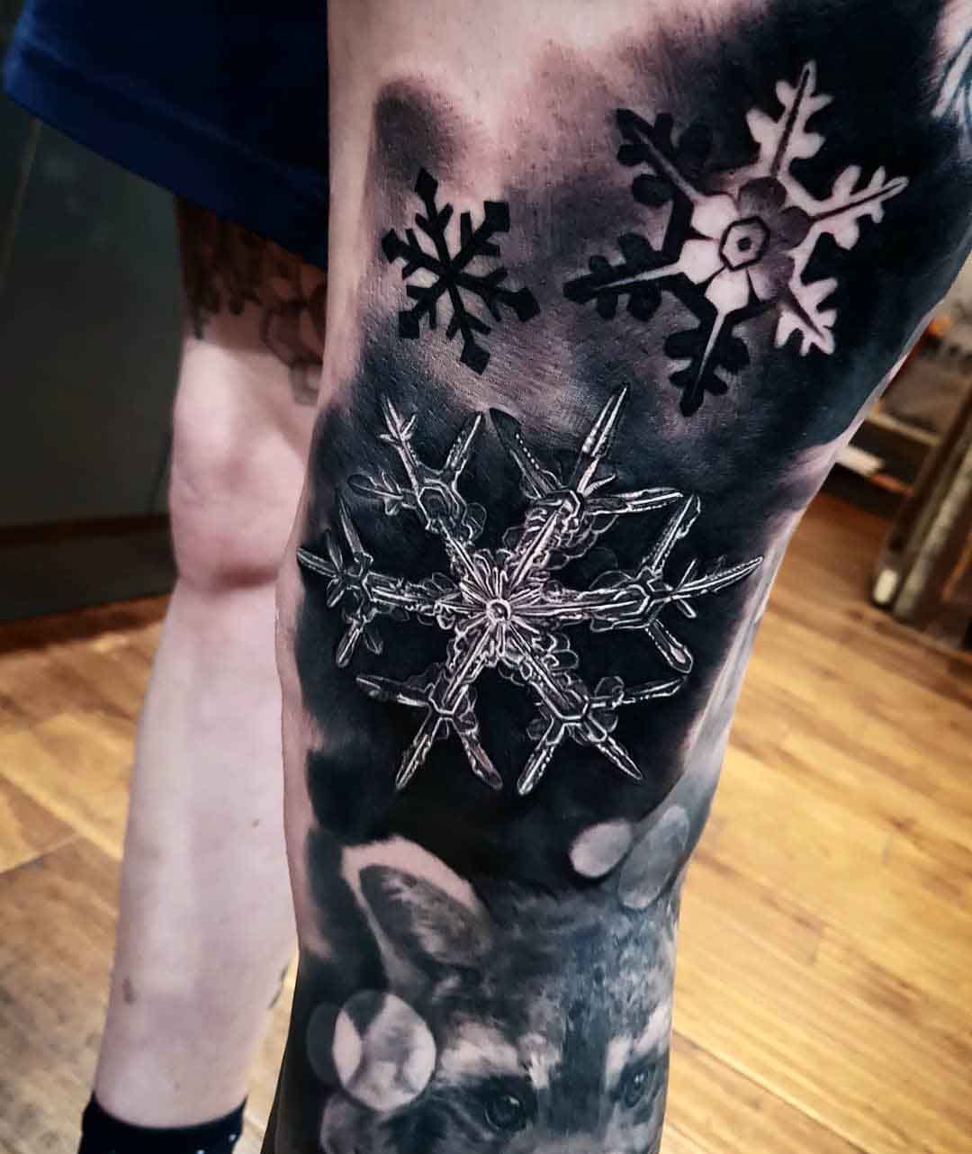 crystal snowflake tattoo on leg