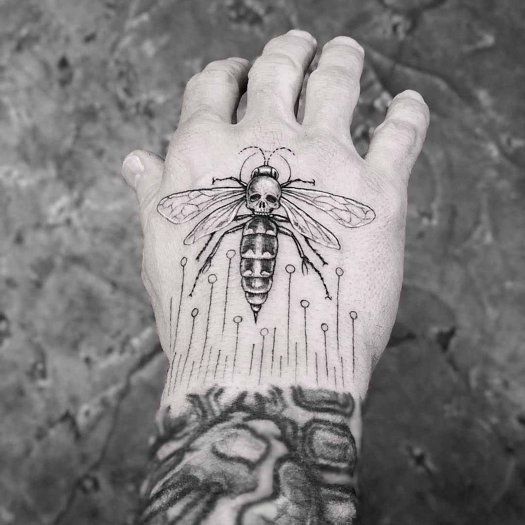 hand tattoo wasp with skull