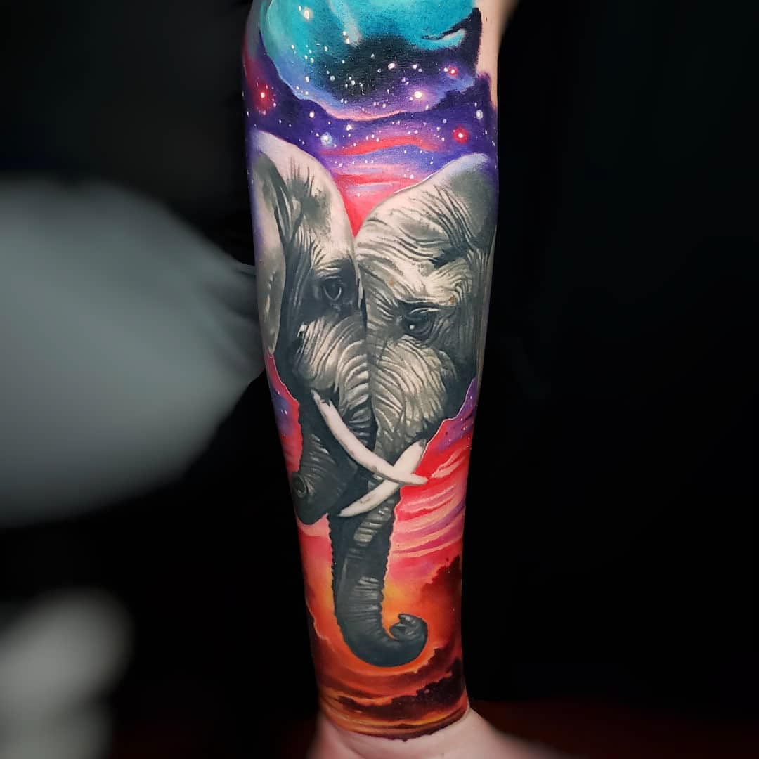 two elephants tattoo on arm
