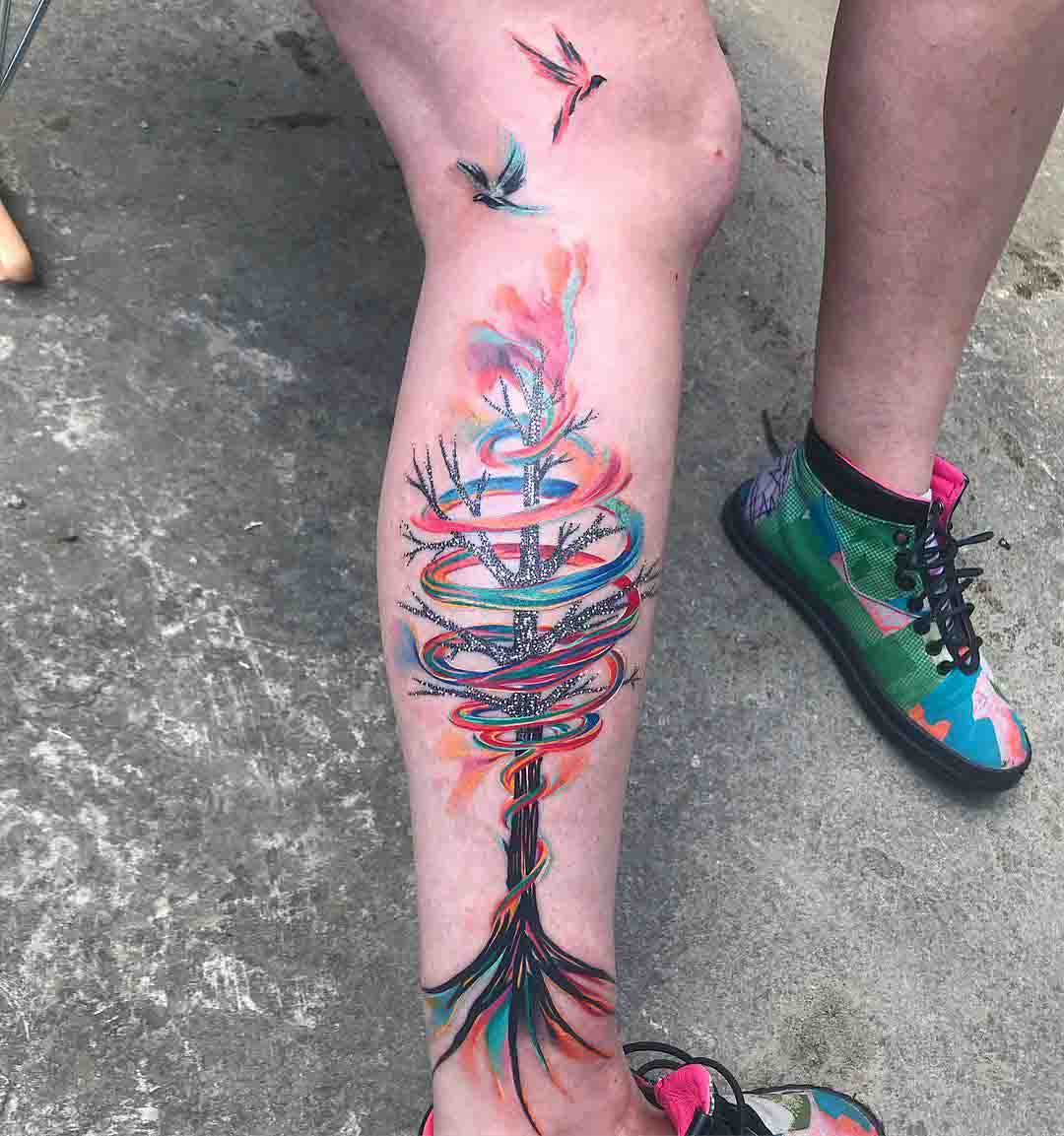 tree tattoo on calf made of rainbow
