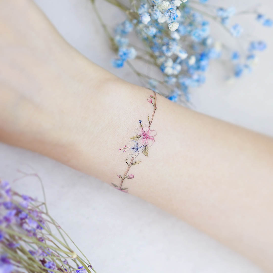 flower tattoo around the wrist