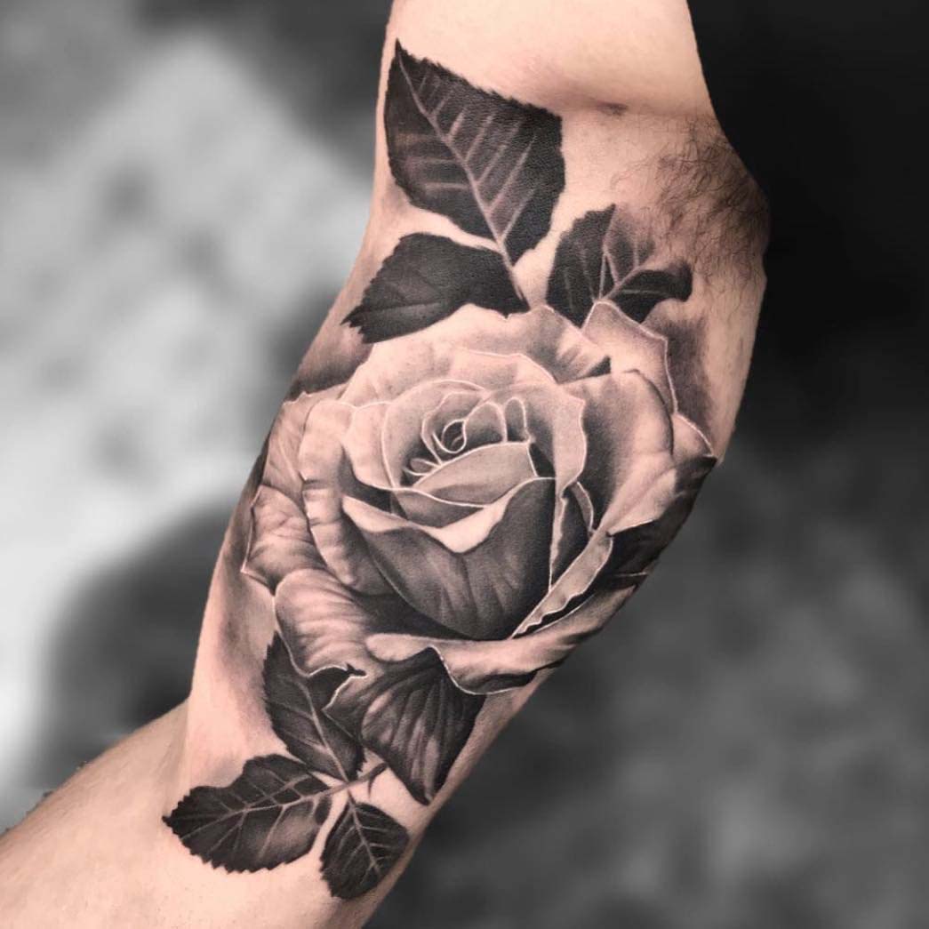 rose tattoo on innder bicep