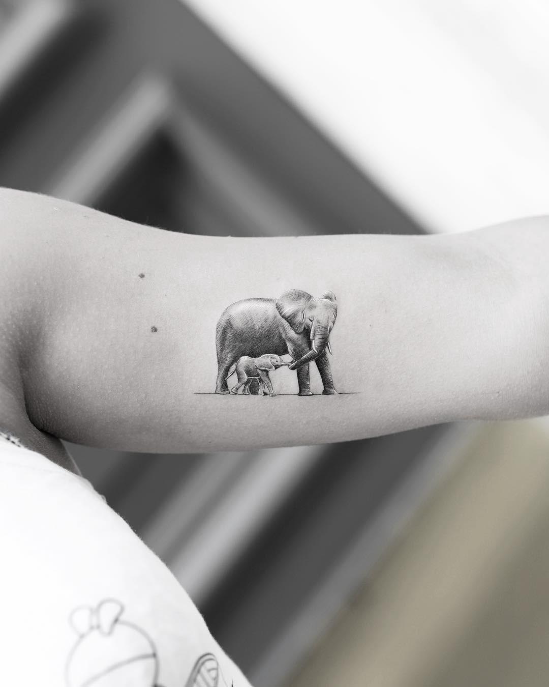bicep tattoo elephants
