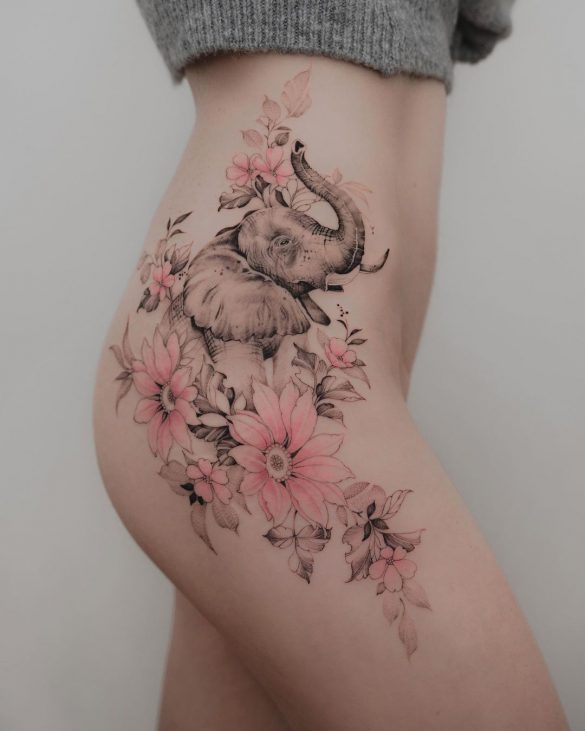 A colorful, creative abstract tattoo of a peacock bird decorates this  girl's hip | Ratta Tattoo